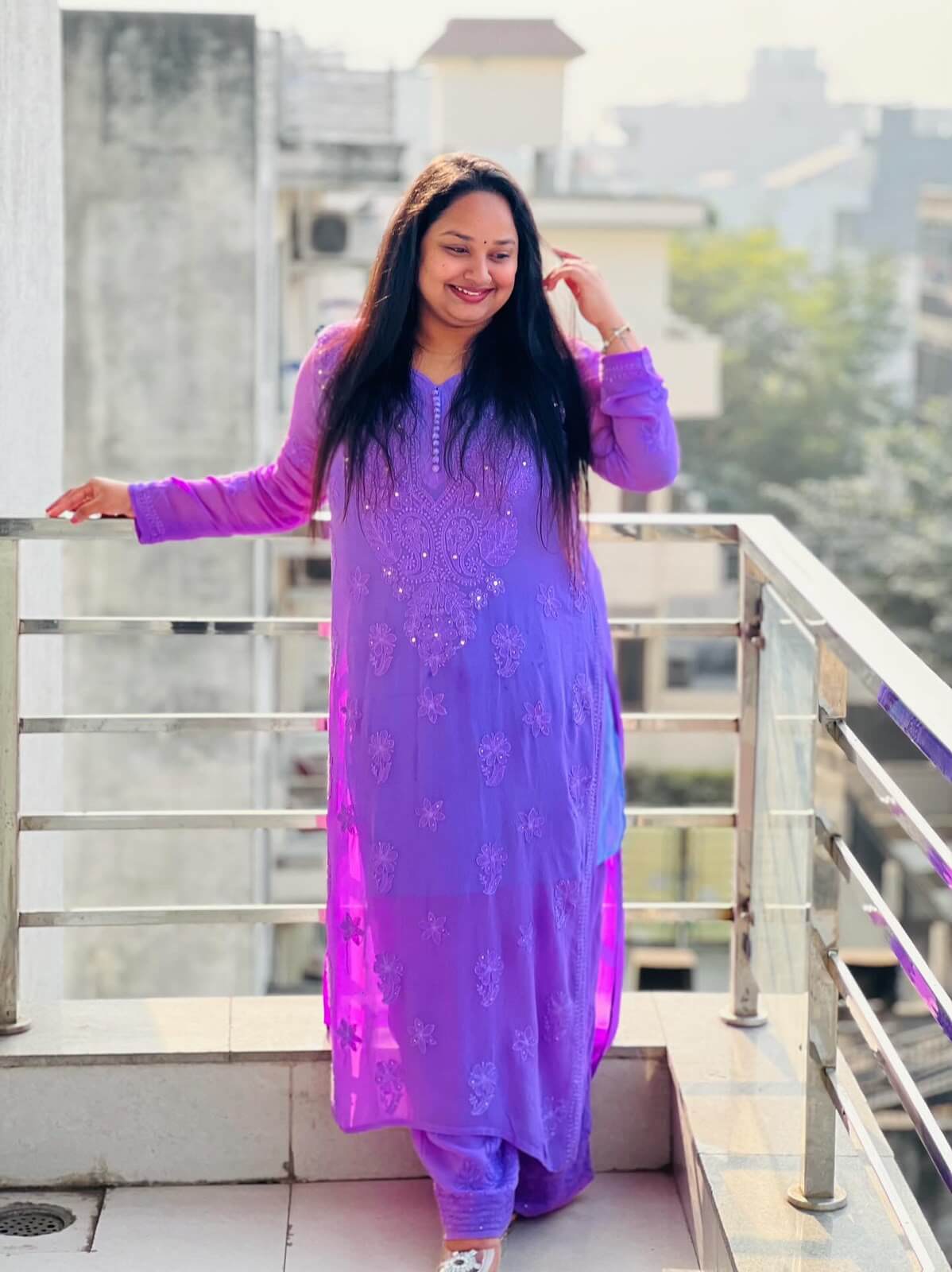 Customer in a purple chikankari kurta on a balcony